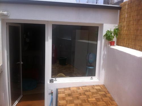 a sliding glass door in a room with at Casinha Azul in Horta
