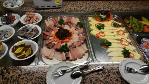 a tray of different types of food on a table at Hotel zur Post Kleve in Kleve