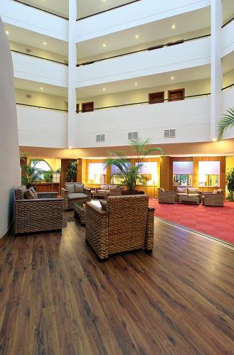 a large lobby with couches and chairs in a building at Fortuna Beach Hotel in Marmaris