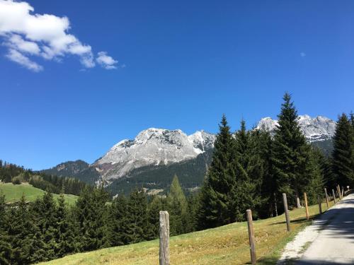 a road with a mountain in the background at Apartment Krämerhaus Annaberg, Dachstein West in Annaberg im Lammertal