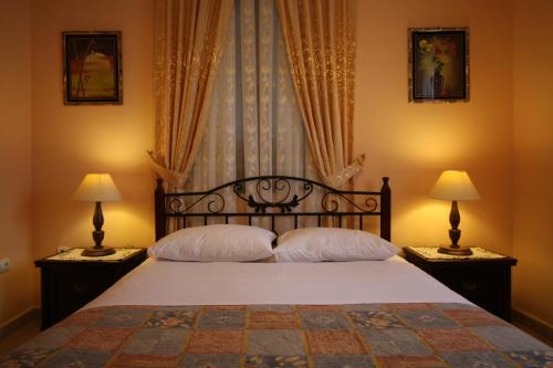 
a hotel room with a bed and a lamp at Sofia Pension in Rhodes Town
