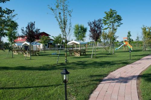 a park with a playground and a pathway at Carpe Diem Countryhouse in Cesarolo