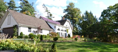 a white house with a landscaped yard at Briarwood Bed & Breakfast in Elmsdale