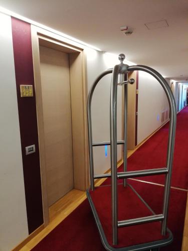 a room with a treadmill in front of a door at Al Marinaio Hotel Garni in Trento