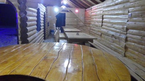 a large wooden table in a room with wooden walls at Плай in Verkhovyna