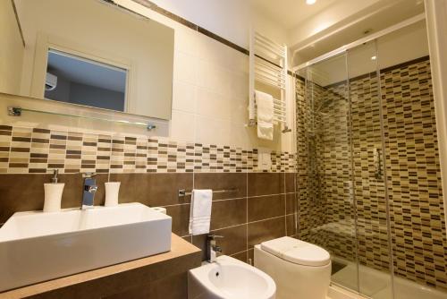 a bathroom with a sink and a toilet and a shower at Un B&B al Belvedere in Enna