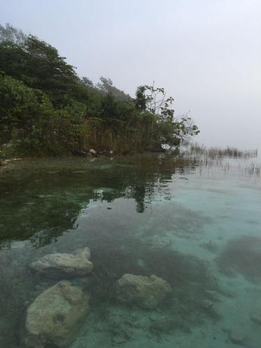 a large body of water with rocks in it at El Roble Nature Hotel & Lagoon in Bacalar