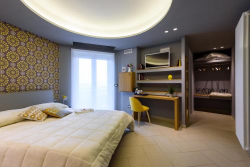 a bedroom with a large bed and a desk at Un B&B al Belvedere in Enna