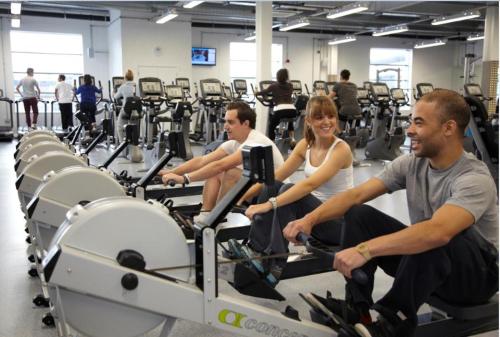 a group of people riding on treadles in a gym at Glasgow Central Station SKYLINE Apartment with Parking (2 bedrooms, 2 bathrooms, 1 living room-Kitchen) in Glasgow