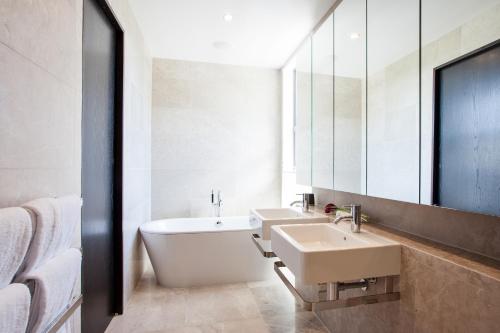 a bathroom with two sinks and a large mirror at Kakara Moana in Queenstown