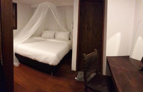 a bedroom with a white bed with a canopy at The Good Days in Udon Thani