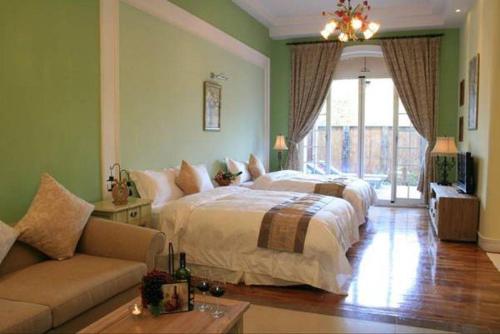 a large bedroom with a bed and a couch at My Chateau Resort in Kenting