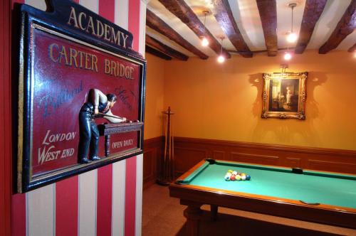 a room with a pool table and a sign at Hôtel la Residence Du Berry in Versailles
