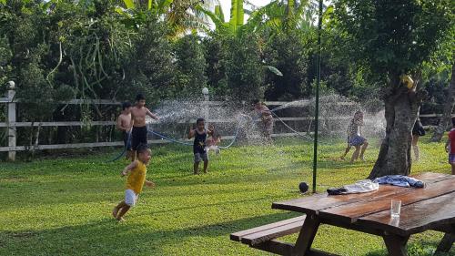 a group of people playing in a park at Happy Farm Tien Giang Homestay in My Tho