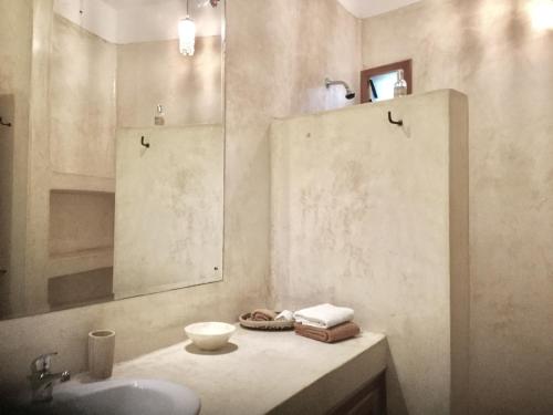 a bathroom with a sink and a mirror at Bena House Kenya in Watamu