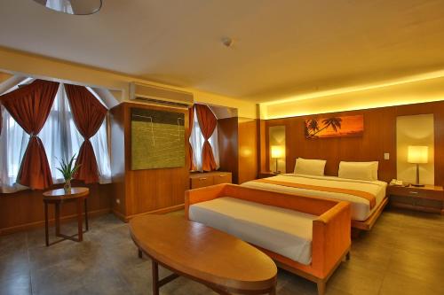 a hotel room with a bed and a table at Crown Regency Beach Resort in Boracay