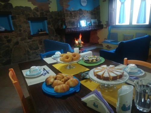a table with food on it with a fireplace at B&B La Dolce Sosta in Fonni
