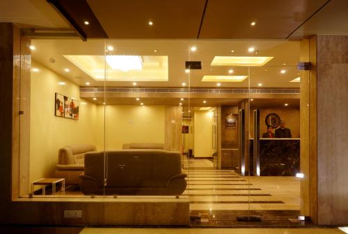 a waiting room with a couch in a lobby at Amalfi Grand in Patna