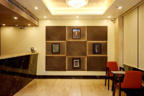 a waiting room with a wall with pictures on it at Amalfi Grand in Patna