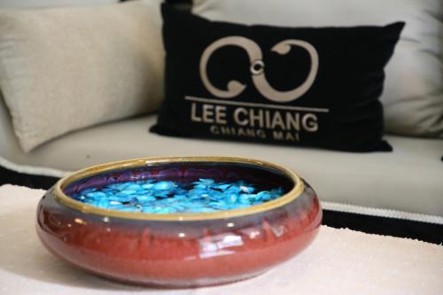 a bowl of blue glitter sitting on a table with a pillow at Lee Chiang Hotel in Chiang Mai