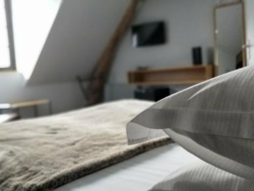 a close up of a bed in a room at Clos Masure hôtel de campagne in Belmesnil