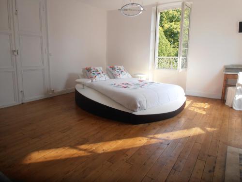 a bedroom with a bed in a room with a window at La Fruitiere in Saints