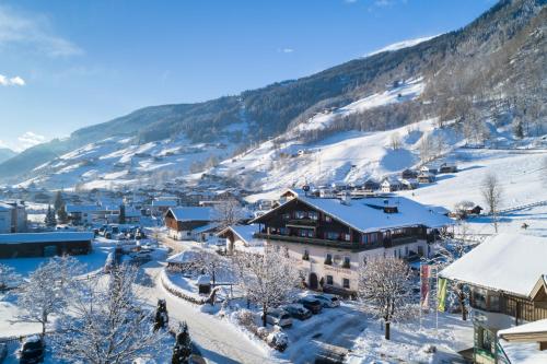 a town in the mountains covered in snow at Hotel Senningerbräu in Bramberg am Wildkogel