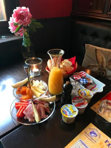 a table with plates of food and a jug of orange juice at B&B Caffètino-Vino in Richterswil