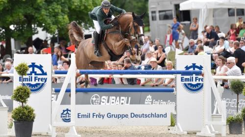 a man riding a horse jumping over an obstacle at Gasthaus Löwen in Dettighofen