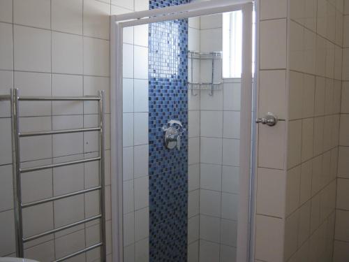 a shower in a bathroom with a glass door at Jetty Self-Catering in Swakopmund
