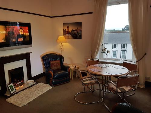 a living room with a table and a fireplace at 5B, Market Place flats in Barnard Castle