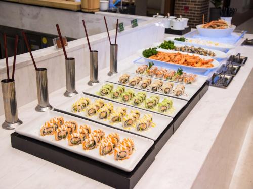 a buffet line with different types of food on display at Hotel Tops 10 in Gangneung