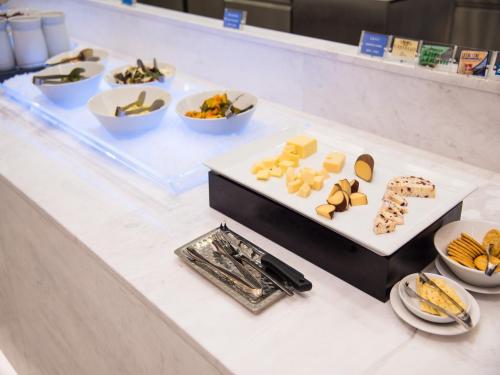 a table with several plates of food on it at Hotel Tops 10 in Gangneung