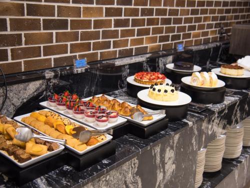 a buffet line with many different types of food at Hotel Tops 10 in Gangneung