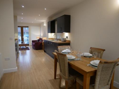 a kitchen and dining room with a table and chairs at 8 Swan House in Carnforth