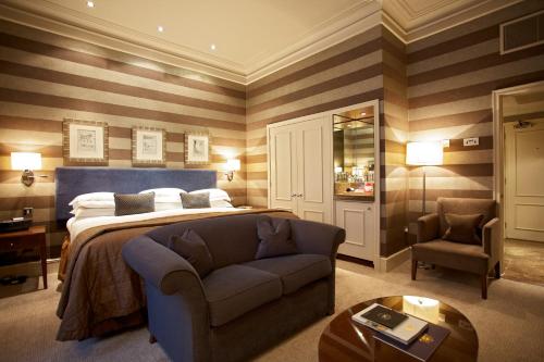 a hotel room with a bed and a television at The Chester Grosvenor in Chester