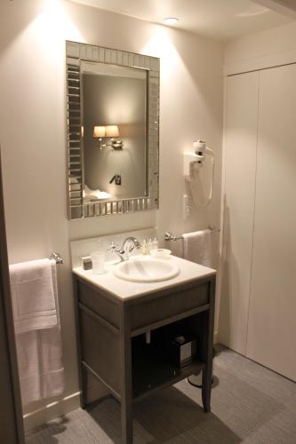 a bathroom with a sink and a mirror at My Home In Paris in Paris