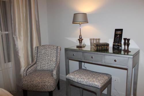 a bedroom with a desk and a chair and a lamp at My Home In Paris in Paris