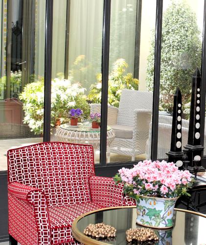 a patio with two chairs and a table with flowers at My Home In Paris in Paris