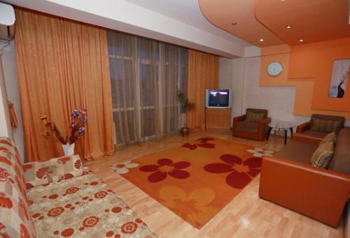 a living room with a couch and a tv at Apartment.md in Chişinău