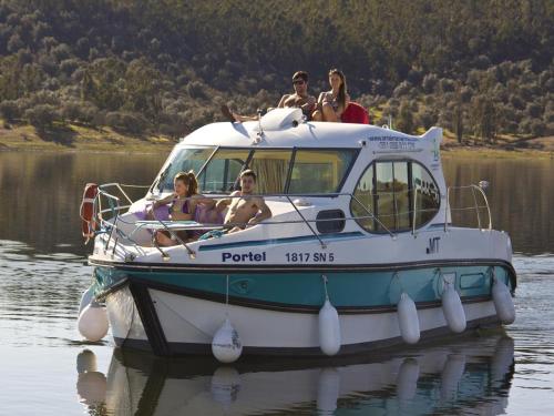 a group of people sitting on a boat in the water at Amieira Marina in Amieira