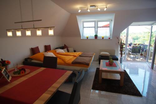 a bedroom with a bed and a couch and a table at Neumann Apartment in Marbach am Neckar