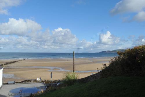 a view of a beach with the ocean at Sea View Guest House in Benllech