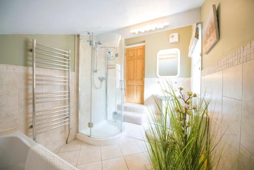 a bathroom with a shower and a bath tub at Georgian Terrace, Chester in Chester