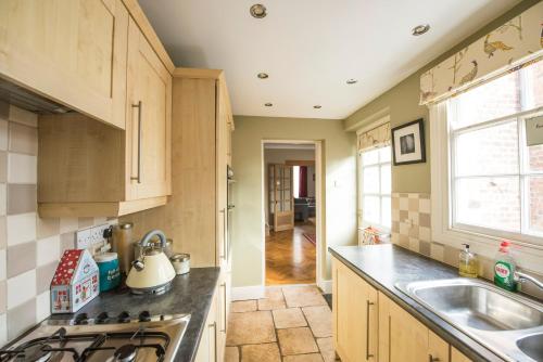 a kitchen with a sink and a stove top oven at Georgian Terrace, Chester in Chester