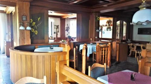 a restaurant with a bar with a table and chairs at Penzion Sumavacek in Bayerisch Eisenstein