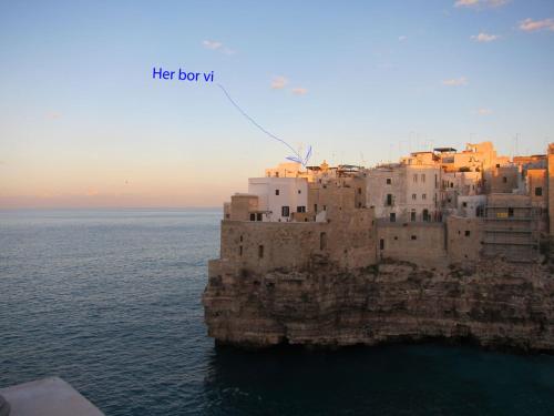 an aerial view of a building on a cliff in the ocean at B&B Casa Dorsi in Polignano a Mare