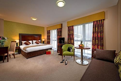 a hotel room with a bed and a couch at George Limerick Hotel in Limerick