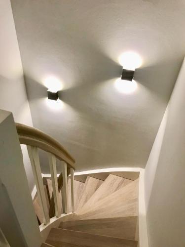 two lights on a ceiling with a staircase at Meer-Lust-Sylt Haus Mateika in Westerland (Sylt)