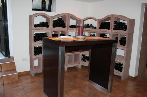 a wine rack with a tasting table in a room at Pension Peterhof in Mörbisch am See